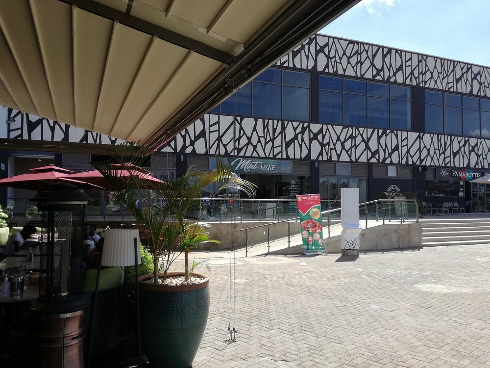 Outdoor dining terraces under the town centre’s geometric facades
