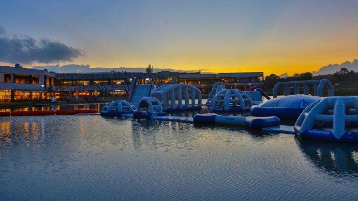 Maji Magic Aqua Park on the lake at dusk — the weekend family ritual